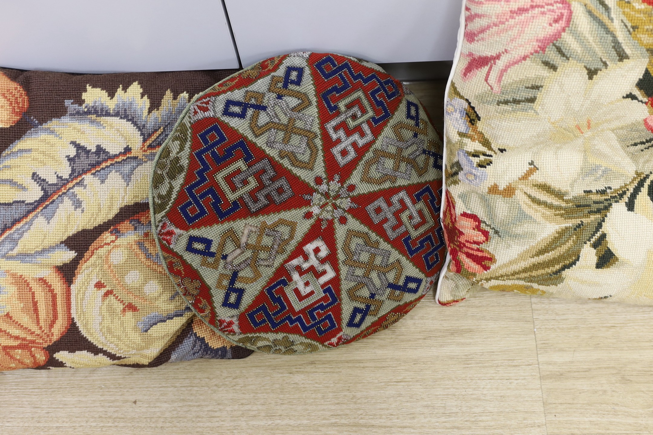 Two pairs of wool work cushions and a 19th century circular Berlin bead work cushion-Berlin bead work cushion 38cms.